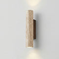 Cylindrical wall light fixture on a plain wall