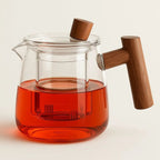 borosilicate glass teapot with infuser and wooden handle in clear