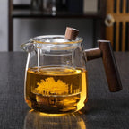 borosilicate glass teapot with infuser and wooden handle in clear