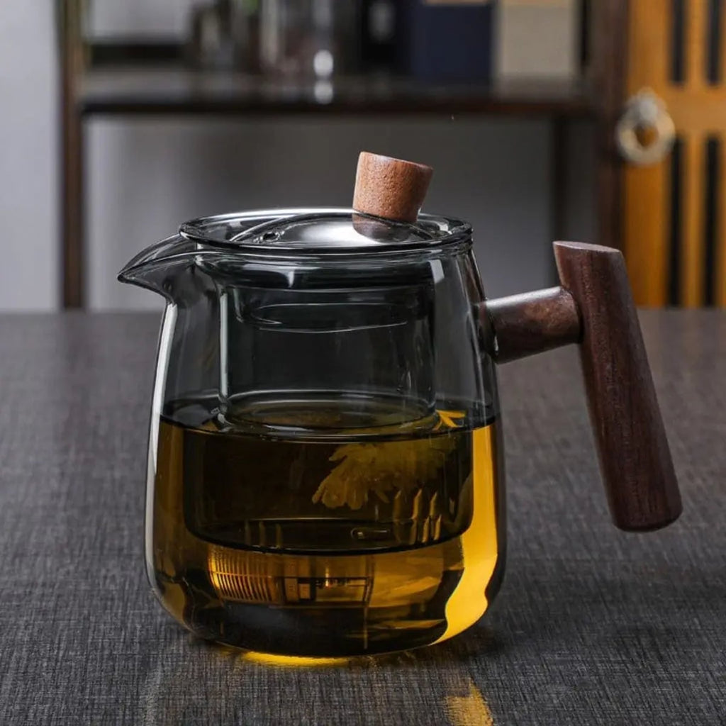 borosilicate glass teapot with infuser and wooden handle in clear