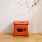 folding step stool with carry handle in dark orange