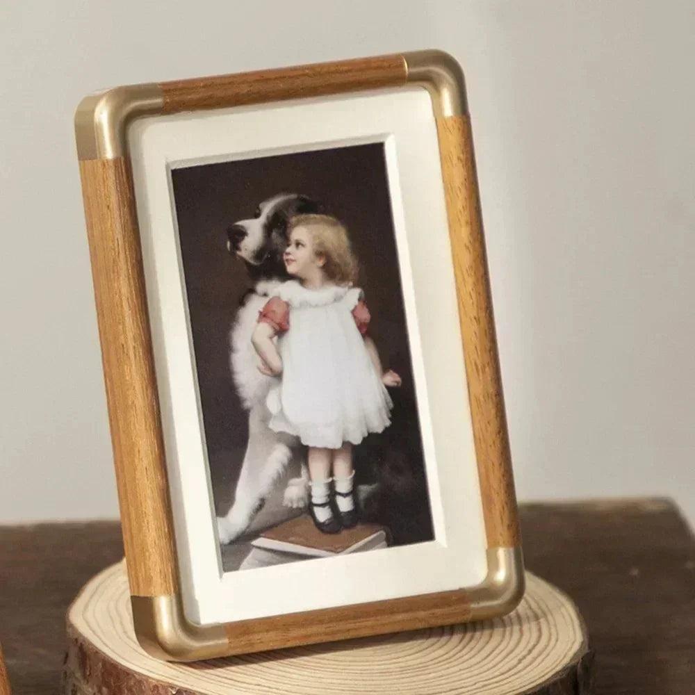 freestanding photo frame with gold corner detail in teak