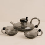 glass teapot set with cups in gray