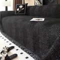 herringbone sofa cover with fringe trim in midnight black