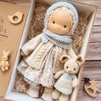 waldorf doll with knitted outfit and gentle animal companion