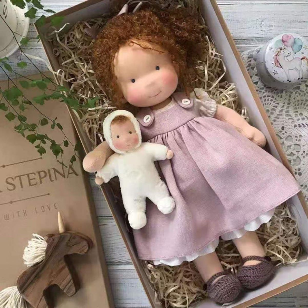 waldorf doll with knitted outfit and gentle animal companion