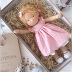 waldorf doll with knitted outfit and gentle animal companion