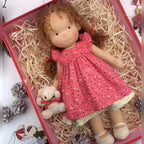 waldorf doll with knitted outfit and gentle animal companion