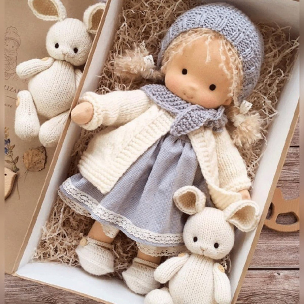 waldorf doll with knitted outfit and gentle animal companion