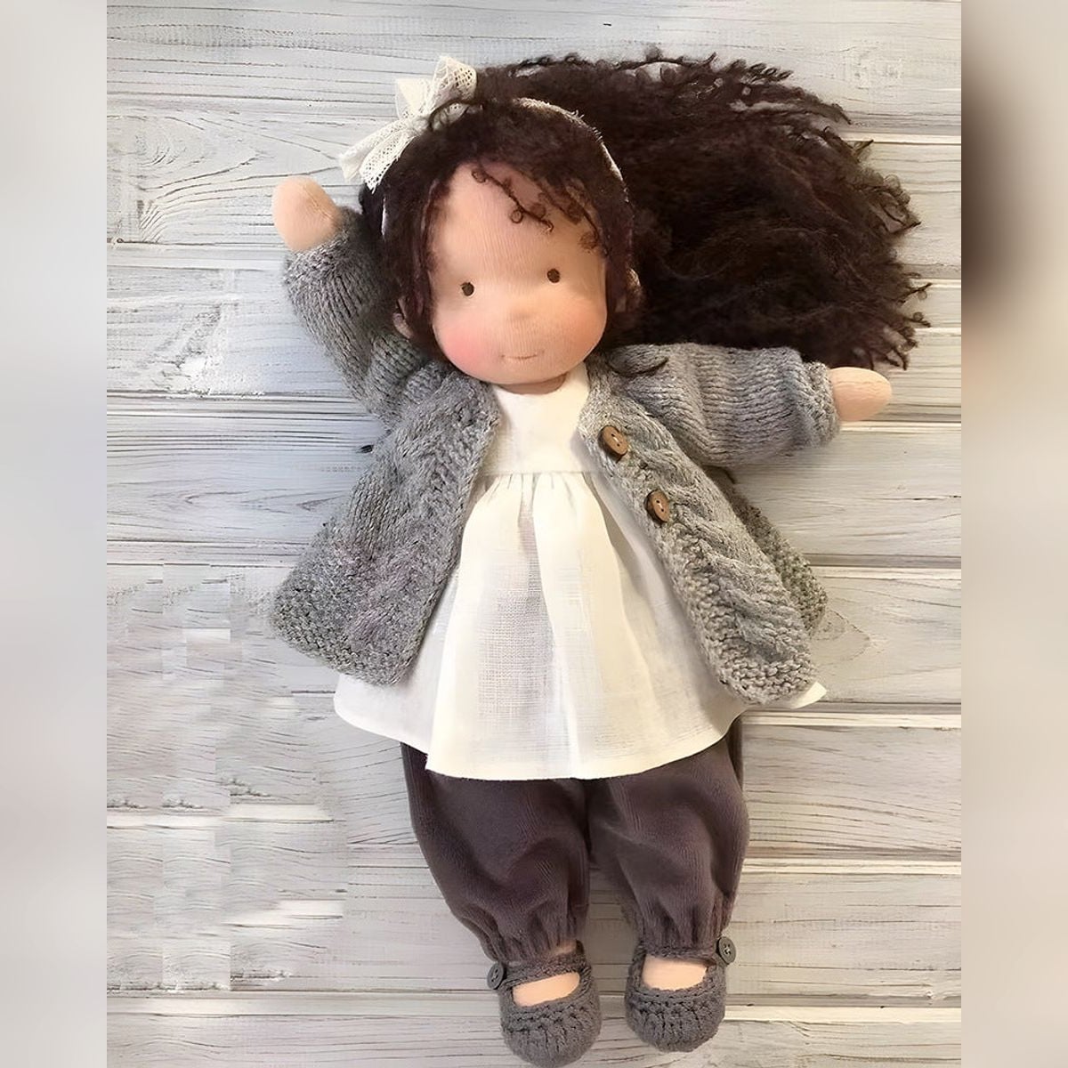 waldorf doll with knitted outfit and gentle animal companion
