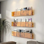 wall-mounted magazine and book display shelf in orange