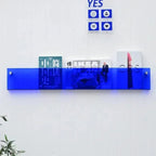 wall-mounted magazine and book display shelf in blue